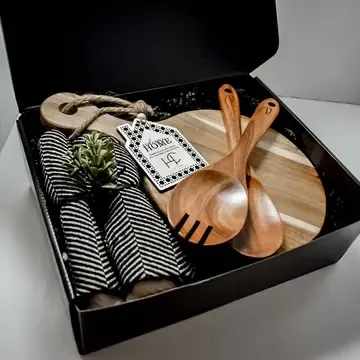 Luxury Hostess Gift  Box -  About this product  Set includes:  One acacia wood cheese board (7.5&quot; x 12.5&quot;) Custom Engraved Gift Tag, Bow, and Greenery Acacia Salad Spoons (set of 2) Turkish Dish Towel   All items are engraved with an industrial grade laser- ensuring they last a lifetime!  Product details  • Made in United States • Product Language: English • Weight: 3 lb (1.36 kg) • Dimensions: 13 x 9 x 6 in (33 x 22.9 x 15.2 cm Product Materials: Plastic-free  Packaging: Recyclable  Production: Cruelty-free and Ethically sourced