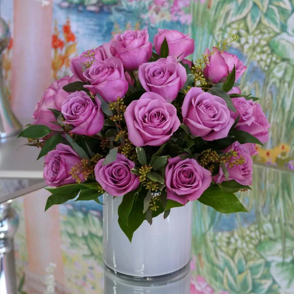 Lavender Day Dreams - 24 Lavender Roses arranged with mixed greens in cylinder vase