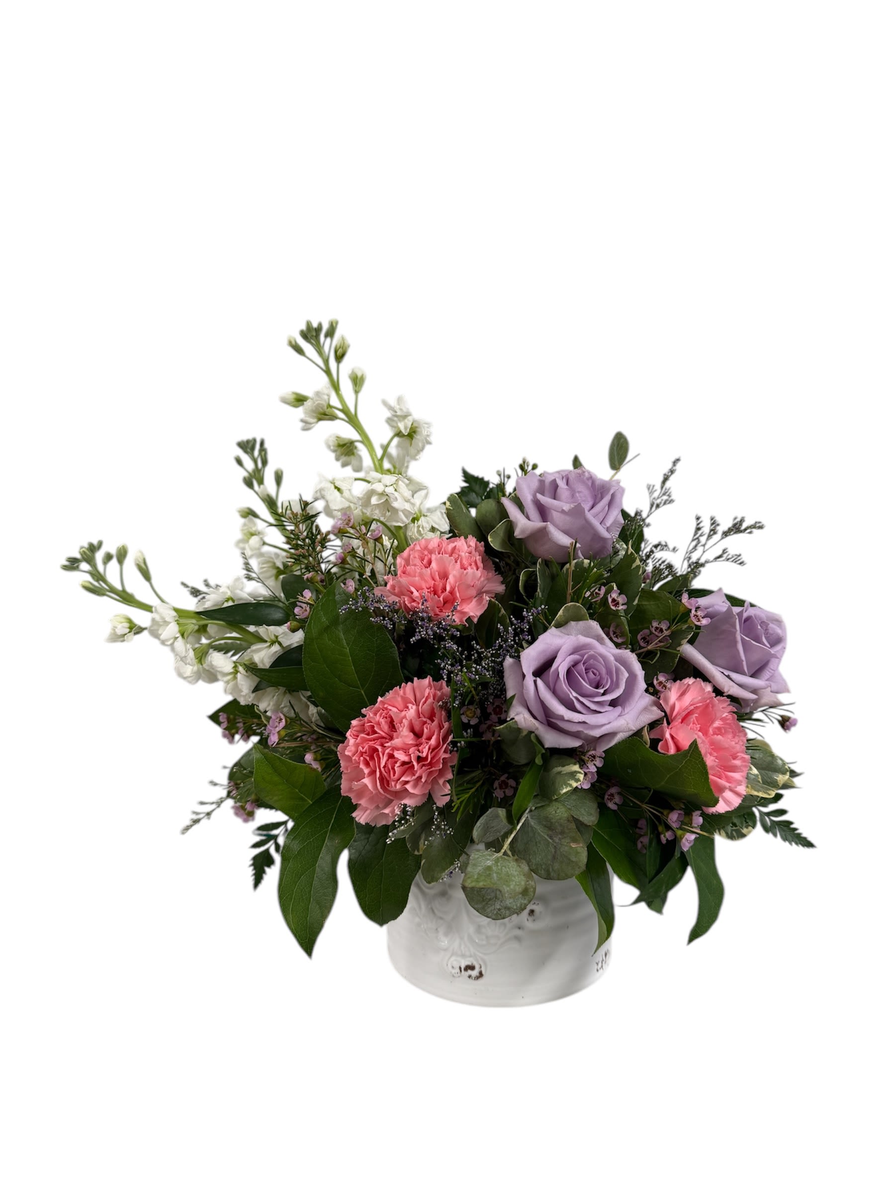 Serene Garden - A serene scene of white stock, pink carnations, and lavender roses accented with eucalyptus, lavender limonium and pink waxflower. This arrangement is designed in a 5&quot; ceramic container.