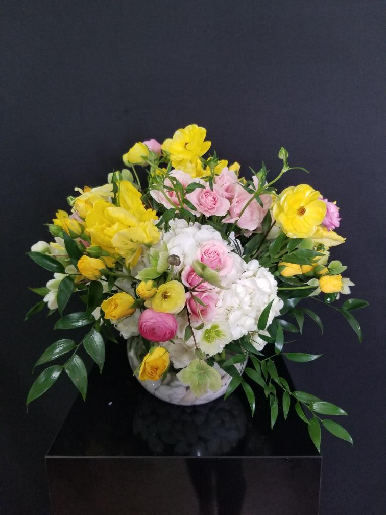 Brighten up someone's day! - The beauty of double tulips and the softness of butterfly ranunculus give this arrangement a little something extra to smile about.   