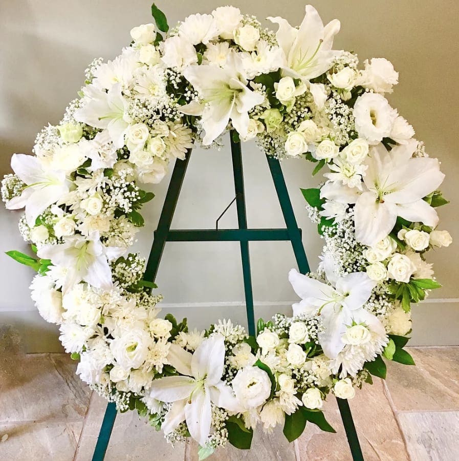 #68 OPEN WREATH WHITE - Lilies, carnations, pompoms  and roses etc    