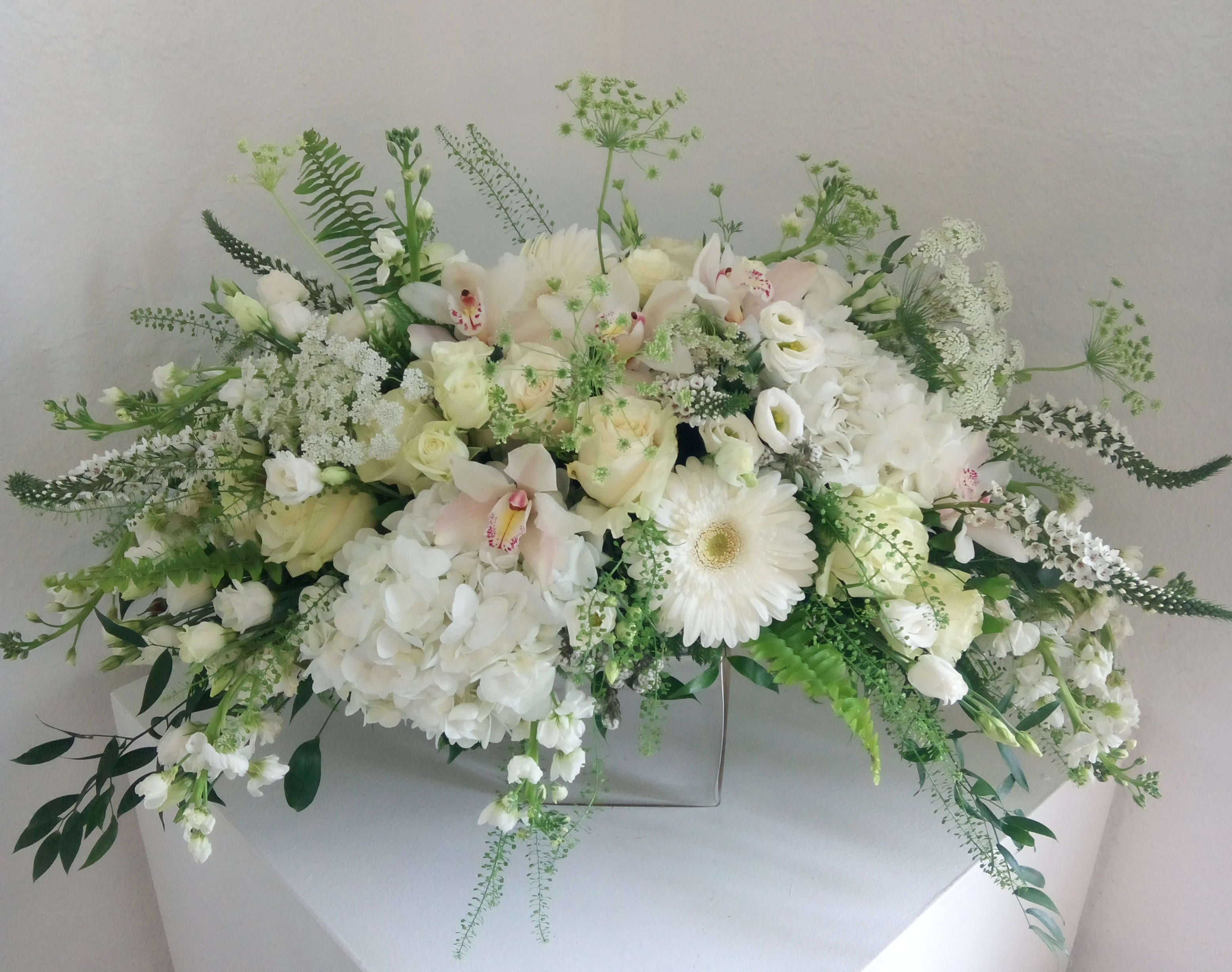 Unclouded Day Casket Spray - Whites, creams and greens soothe the soul in this precious tabletop arrangement. Perfect for a memorial service or tribute table.   
