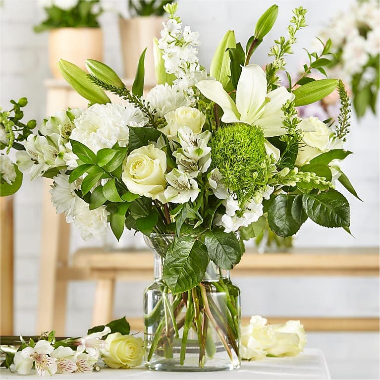 Classic White Designer's Choice  - Please Note: The photo here is an example of the Classic White Floral Arrangement. The exact design and white flowers will vary based on availability.  Flowers chosen will be premium and  daisies, carnations and white spider mums will NOT be used in the arrangement.   Sender may specify flower preferences in special notes. 