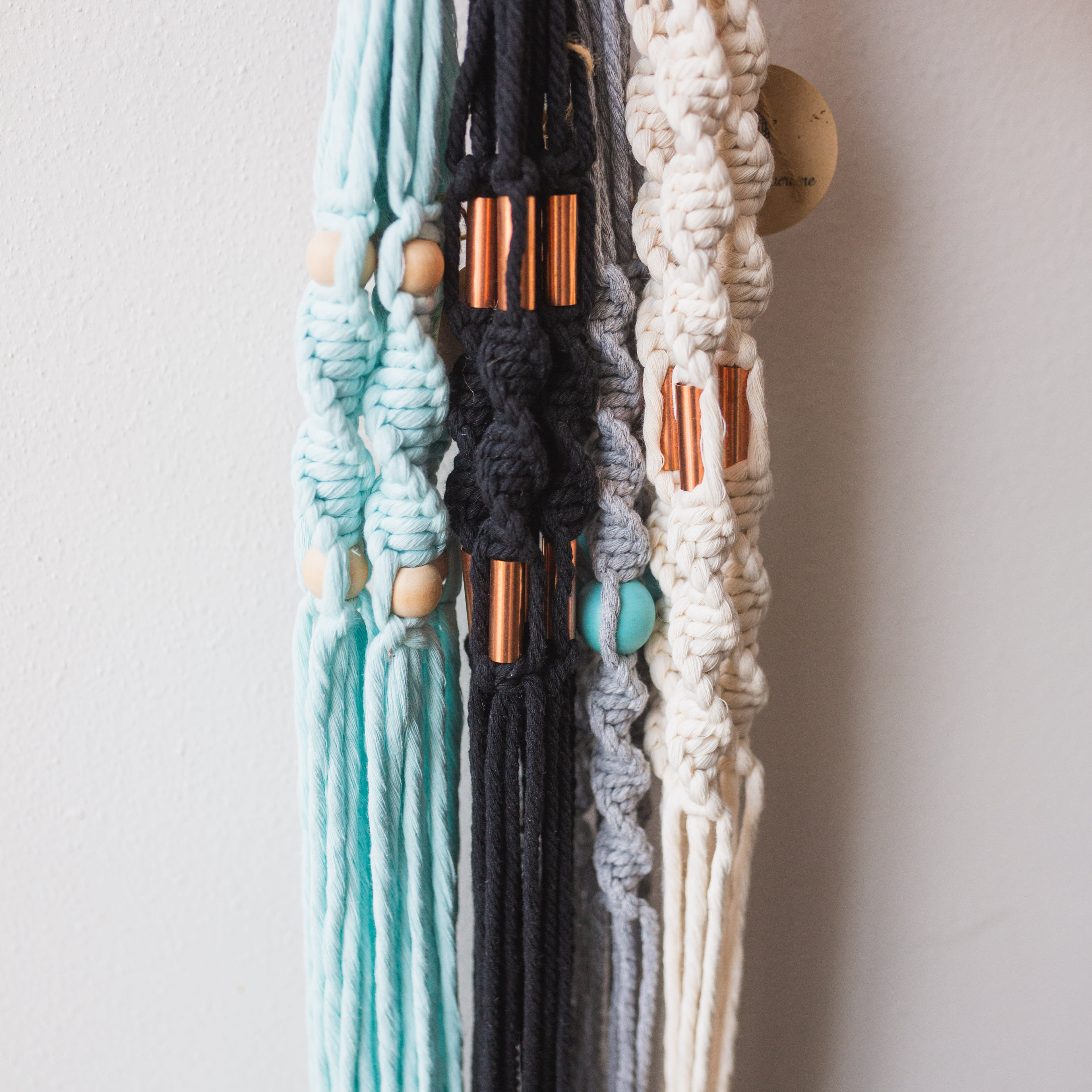 SamanthaMacrame Hand Made Plant Hanger - Gorgeous plant hangers in neutral tones, beaded, braided and knotted with love right here in Minnesota. Perfect for the plant lover in your life!    Please Note: Plant NOT included. Plant pictured is in a 6&quot; pot. Hangers will vary, as they are hand-made goods. Thank you for understanding.