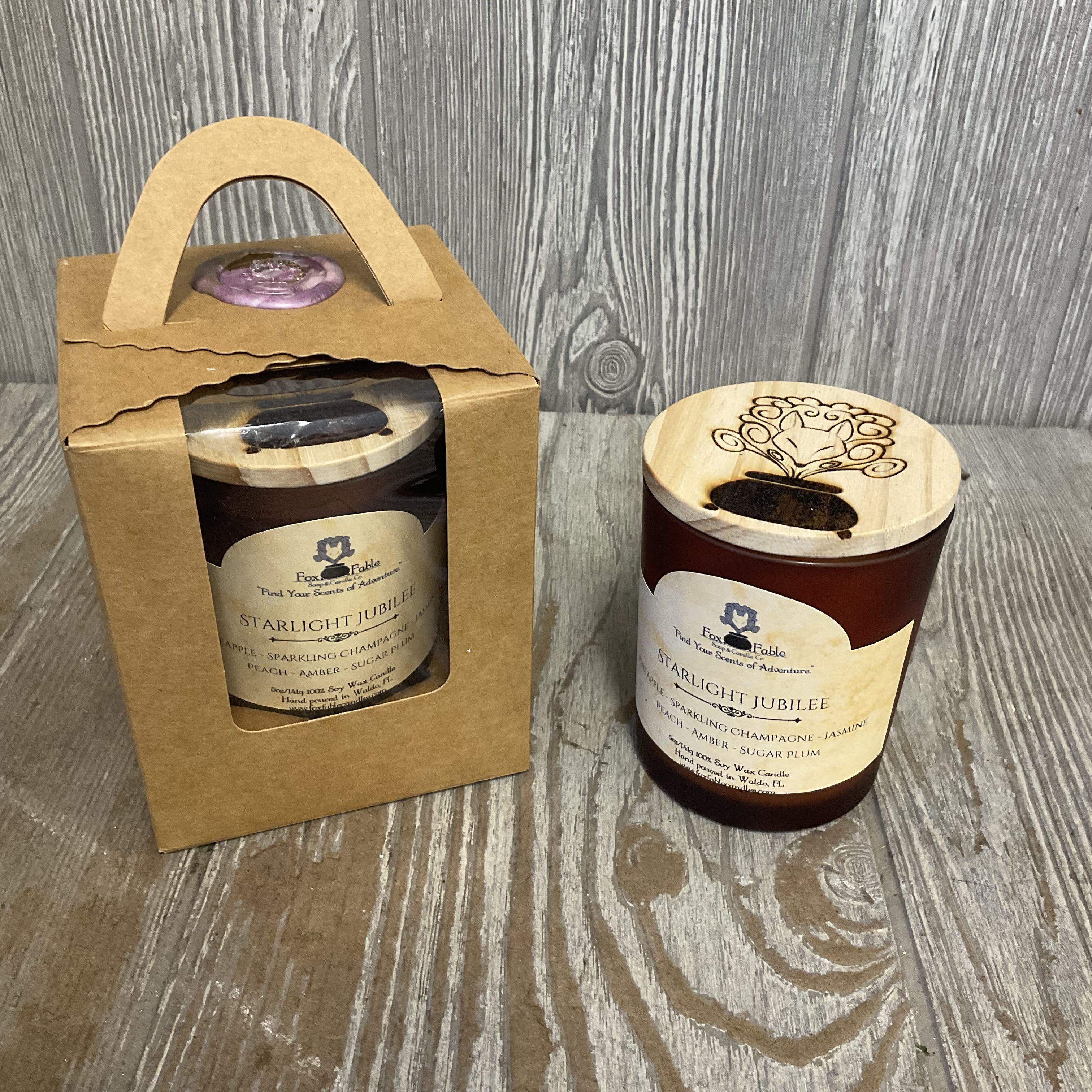 StarIight Jubilee Candle  - Gift the beautiful scent of pineapple, sparkling champagne, jasmine, peach, amber and sugar plum. This scent from Fox Fable Candles, located locally, will make you feel as if you were surrounded by fragrant roses. 100% soy wax candle, 5oz.  Hand poured in Waldo, Florida  Trim wick to 1/4&quot; before lighting. Keep candle free of any foreign and flammable materials including matches and wick trimmings. Burn within sight. Keep away from children and pets. Only burn candle on a level, fire-resistant surface. Do not burn candle for more than four hours at a time. Stop use when only 1/4&quot; of wax remains. 