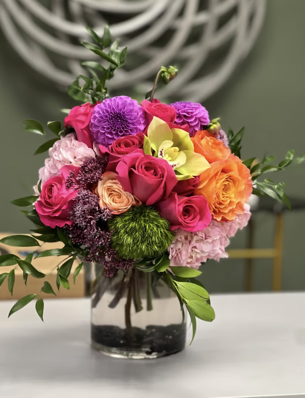 Colorful Blooms Colorful Blooms - Bright and cheery bouquet filled with roses, hydrangeas, orchids, and more in a glass vase. A celebration of color to evoke the essence of spring in full bloom.