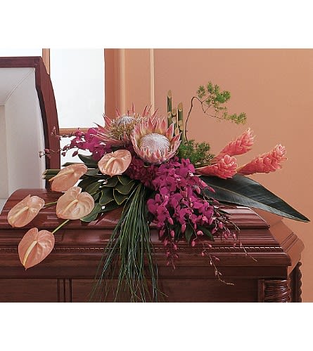 Tropical Paradise Casket Spray Tropical Paradise Casket Spray - This gorgeous spray with its vibrant tropical flowers says what words cannot. One half-couch casket spray arrives styled with pink and purple anthuriums and ginger fuchsia dendrobium orchids and exotic protea along with tropical foliage.