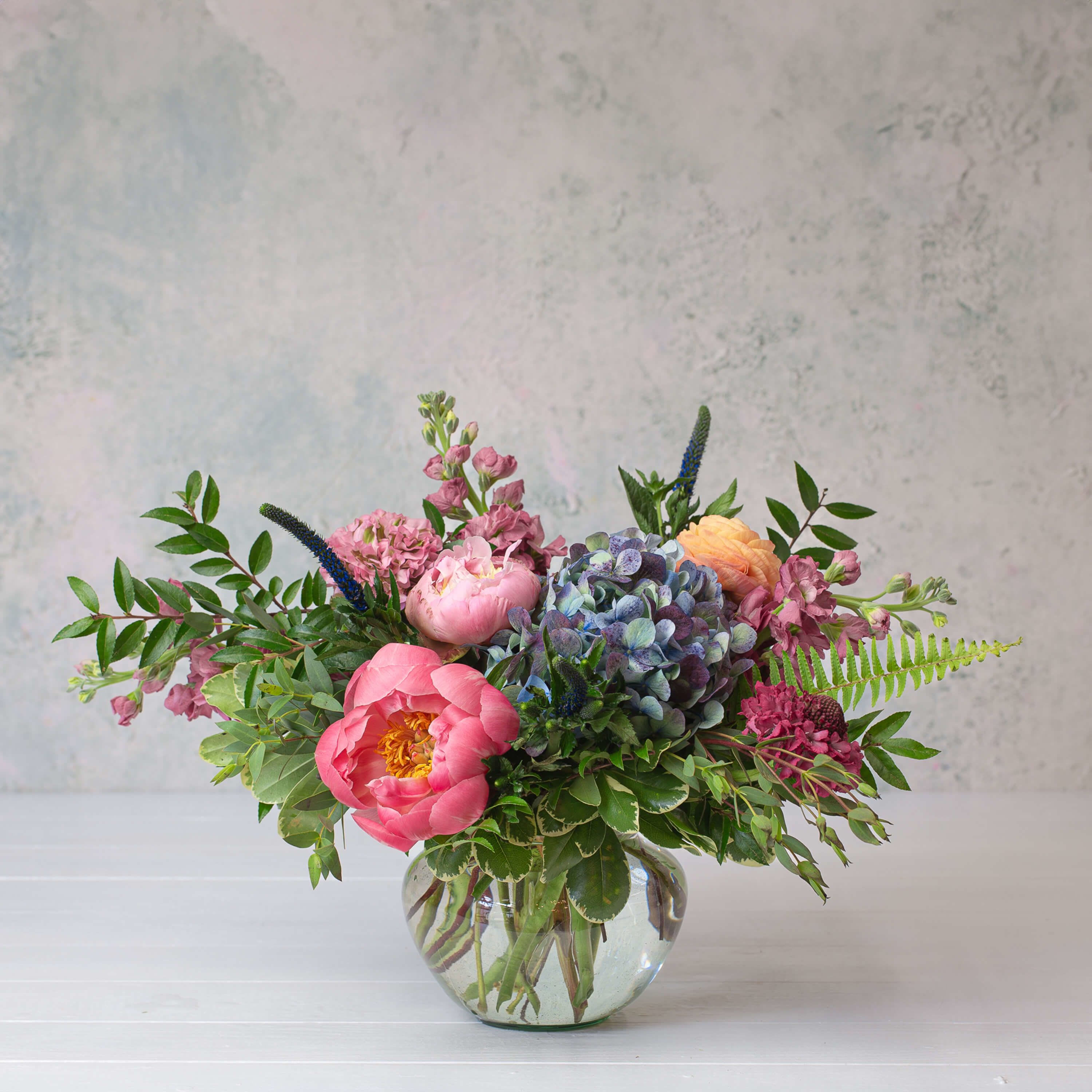 Midnight Masquerade Midnight Masquerade - Keep them guessing. Midnight Masquerade is moody and mysterious. Flowers like Scabiosas, Peonies, and Veronica flowers mix perfectly in this lovely mix.