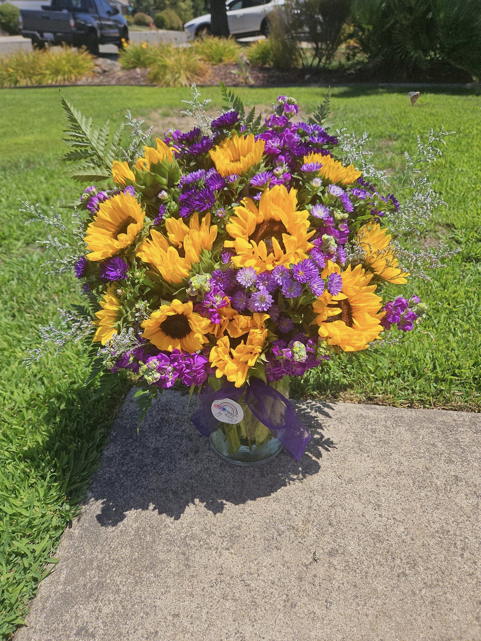 Katey's Sunflower Dream - Sun flowers with dark purple fillers, freshest flowers in season arranged in a vase.