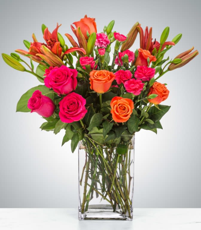 Boss Babe Boss Babe - This arrangement is electric! Send this bright orange and hot pink rose arrangement to make a big impression. Approximate Dimensions (Standard): 15"D x 20"H