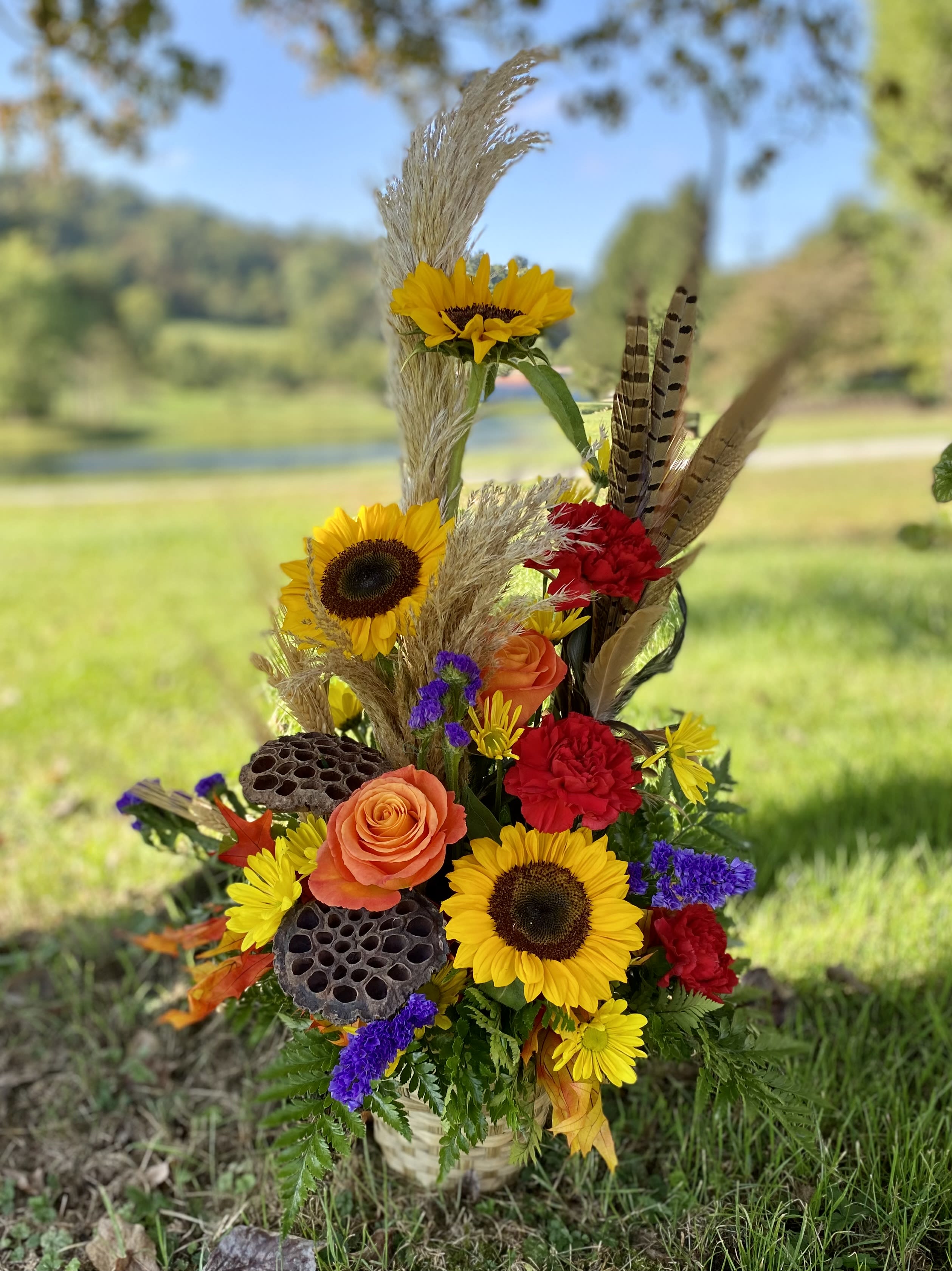 Basket Of Jewel Tones Designer’s Choice - This striking fresh arrangement features the gorgeous jewel tone colors of fall. Perfect for Thanksgiving decor, this beauty truly brightens any room.  We will choose the most vibrant Autumn shades and the freshest flowers to create this arrangement for you, so there may be slight differences from the photo shown. 