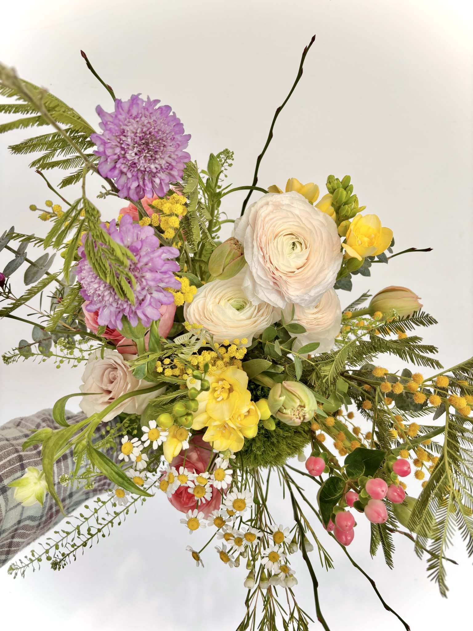Garden Bliss Garden Bliss - An effortlessly airy bouquet that captures the essence of a garden, featuring a dynamic mix of ranunculus, freesia, scabiosa in a vibrant spectrum of colours.