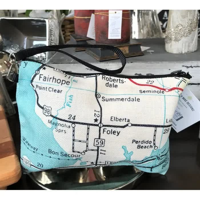 Lower Baldwin Map Wristlet Lower Baldwin Map Wristlet - Love lower Alabama? These 9"x6" cloth zippered pouches feature a map of Lower Baldwin County on both sides. They are a generous size to hold all your necessities. There is a black zipper and woven black wrist strap.