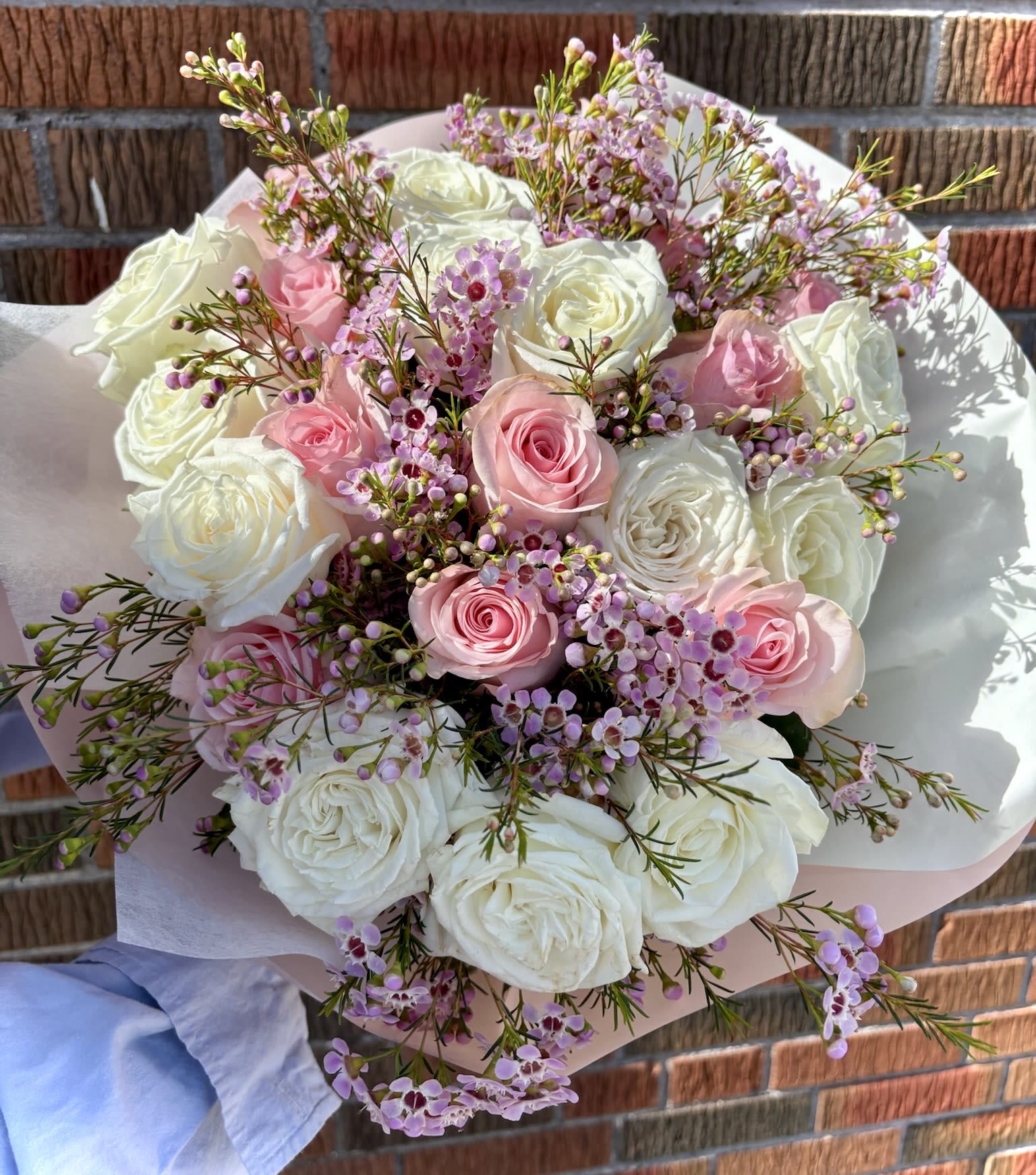 Pink Dreams Pink Dreams - Hand-tied bouquet with white and pink roses & wax flowers.