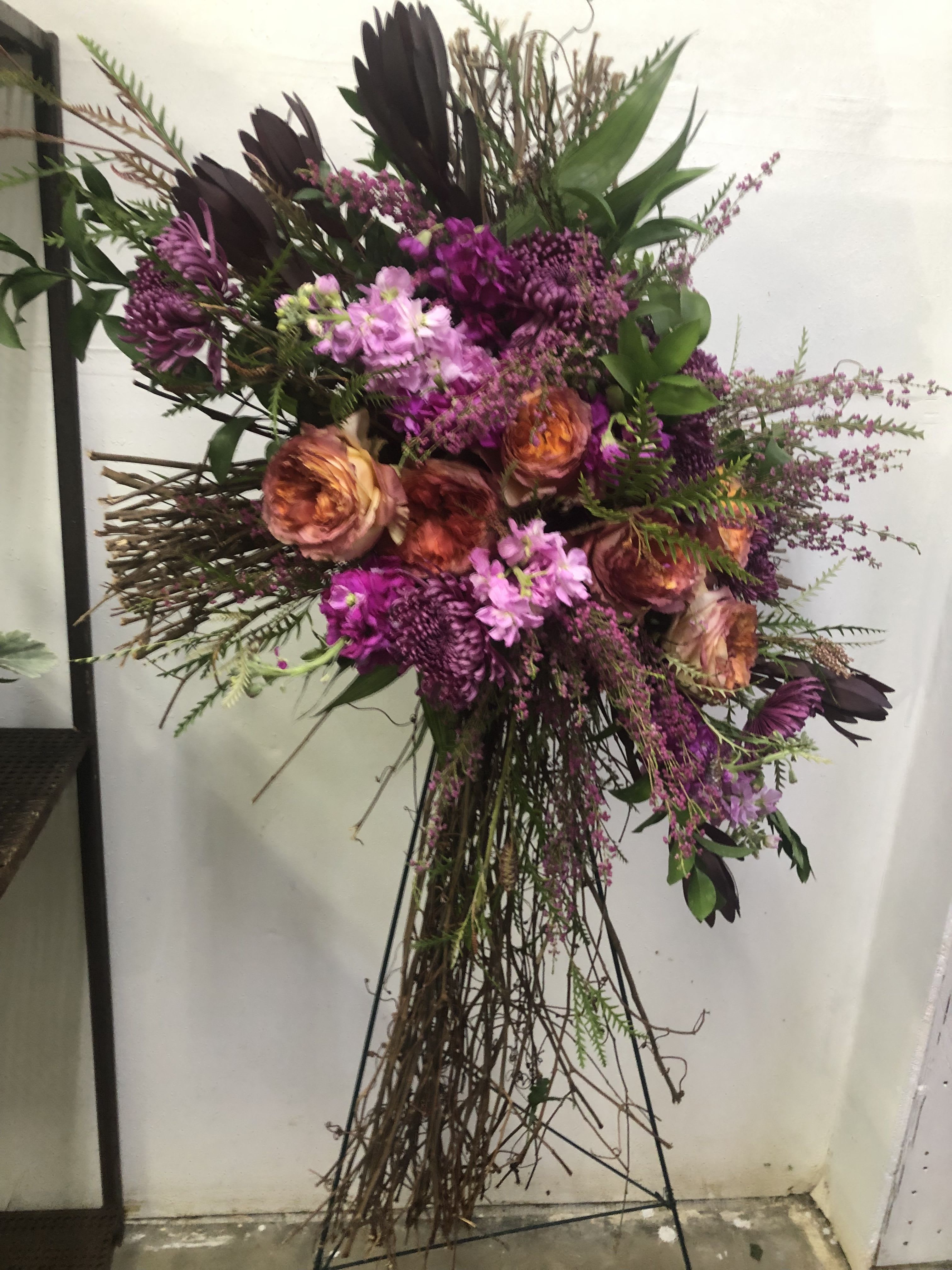 Wooden Cross - pink, burgundy, and orange on a grapevine cross