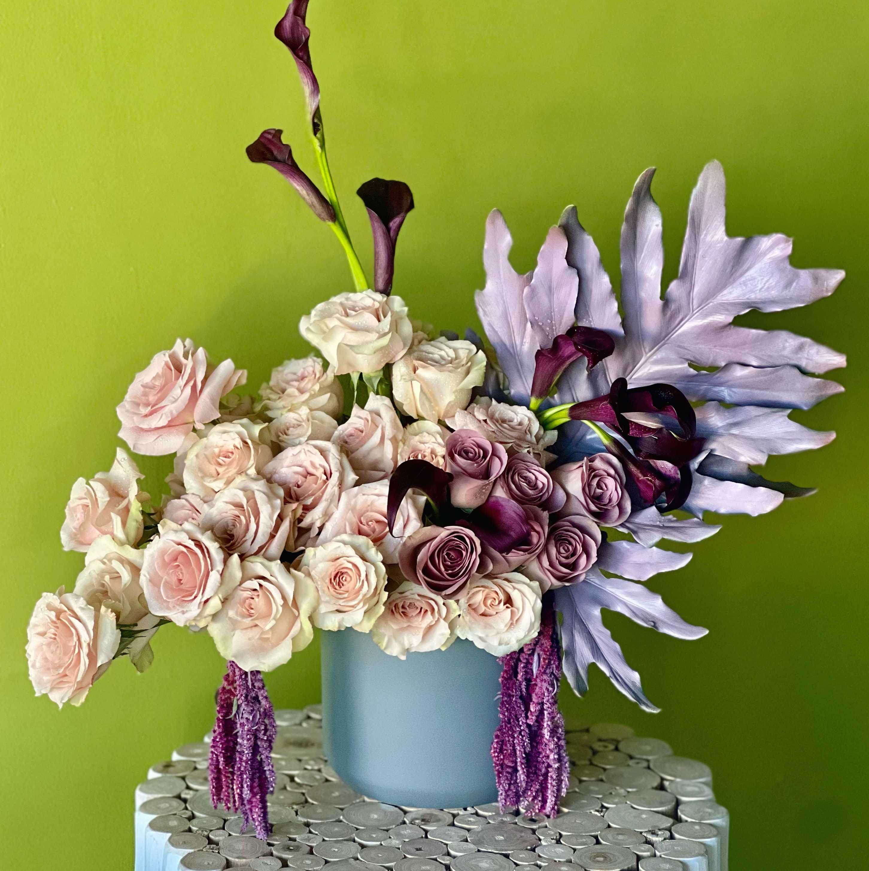 Purple leaf Purple leaf - Roses and Cala Lilies in a gray ceramic vase