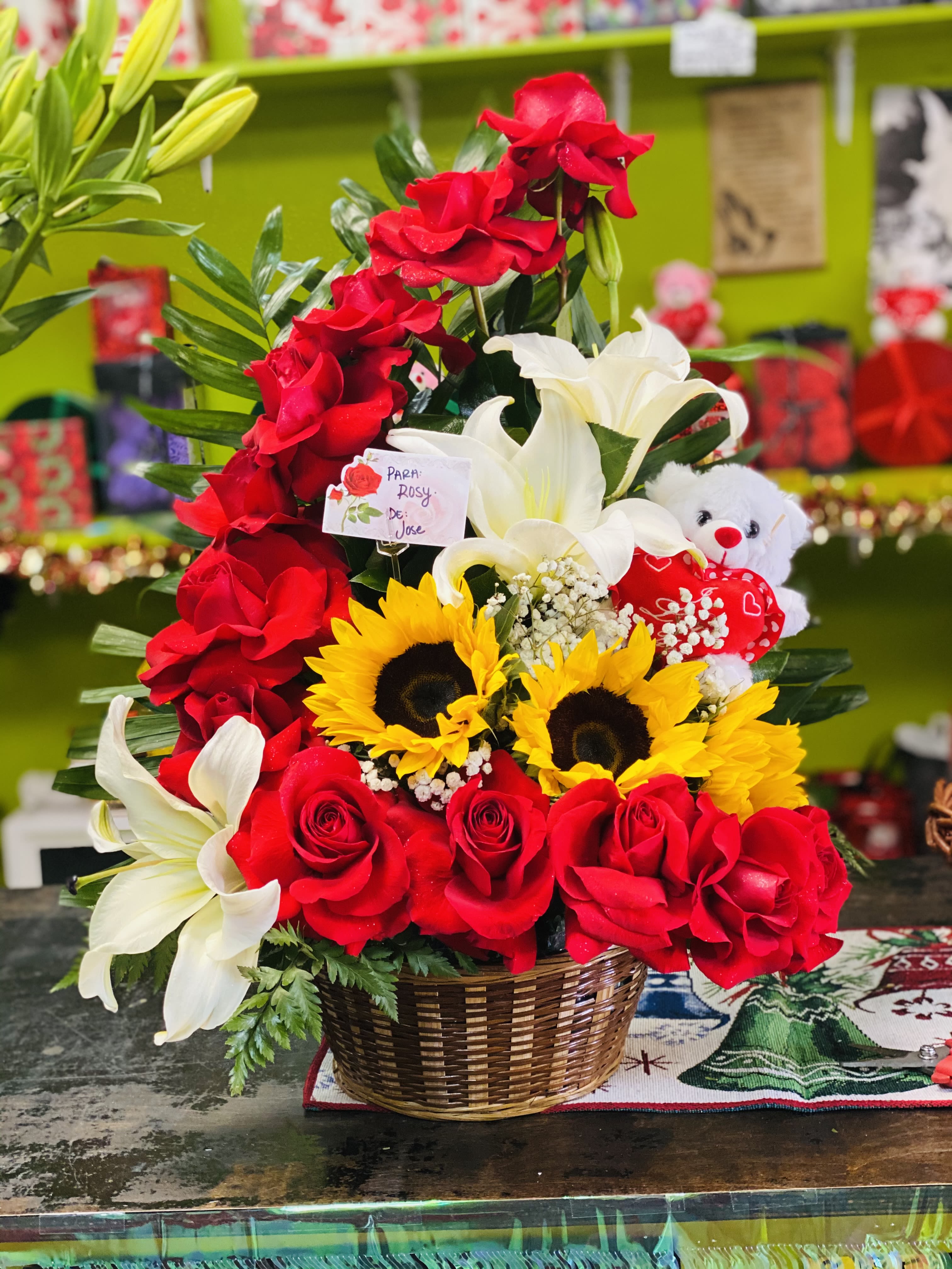 Half moon  - 12 red open roses 3 sunflowers +2 lilies in a basket with a bear 