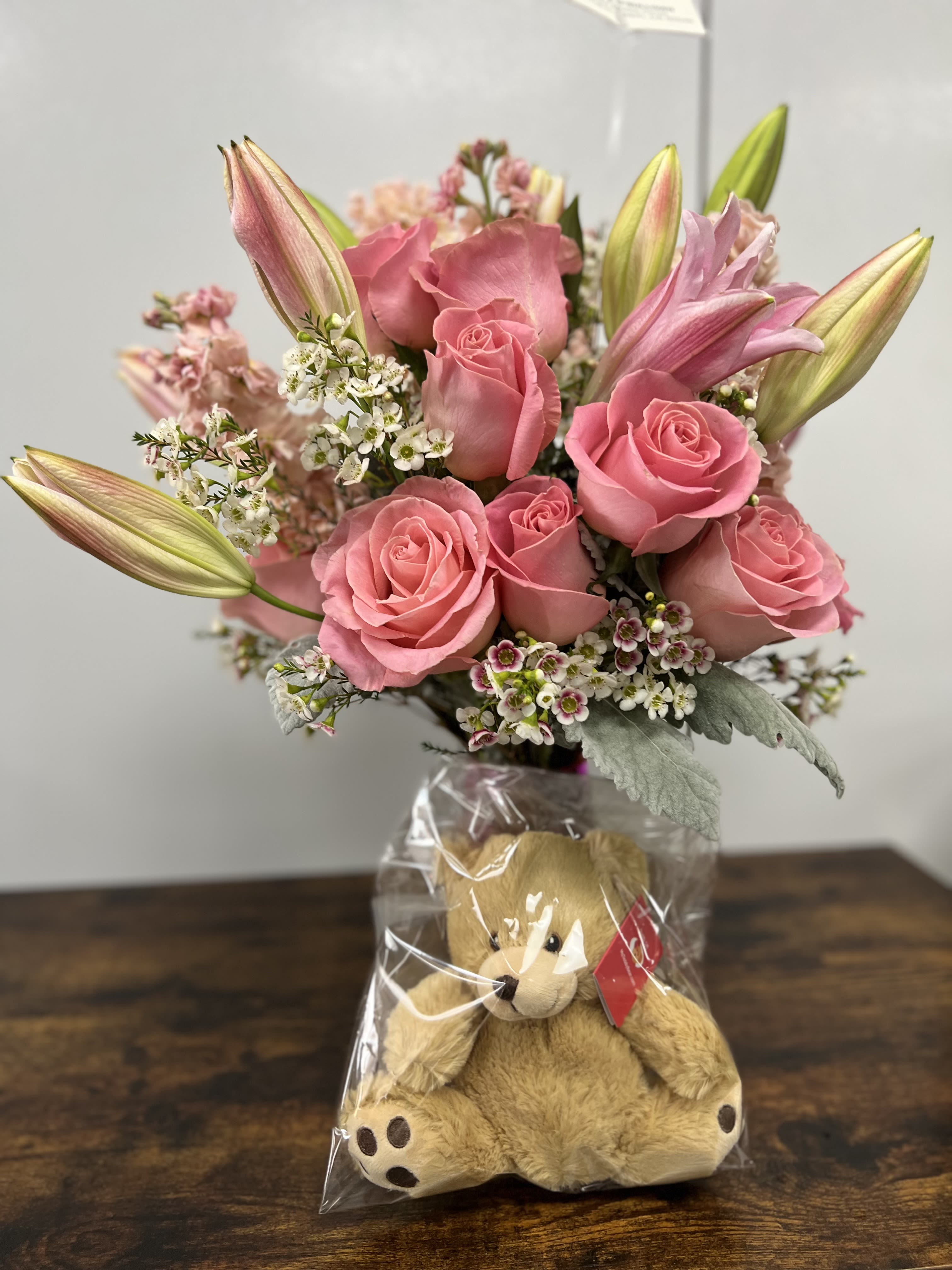 Beary Pink Beary Pink - Pink Roses and Pink Lilies with mix of greens and wax flowers in a pink vase and small bear.