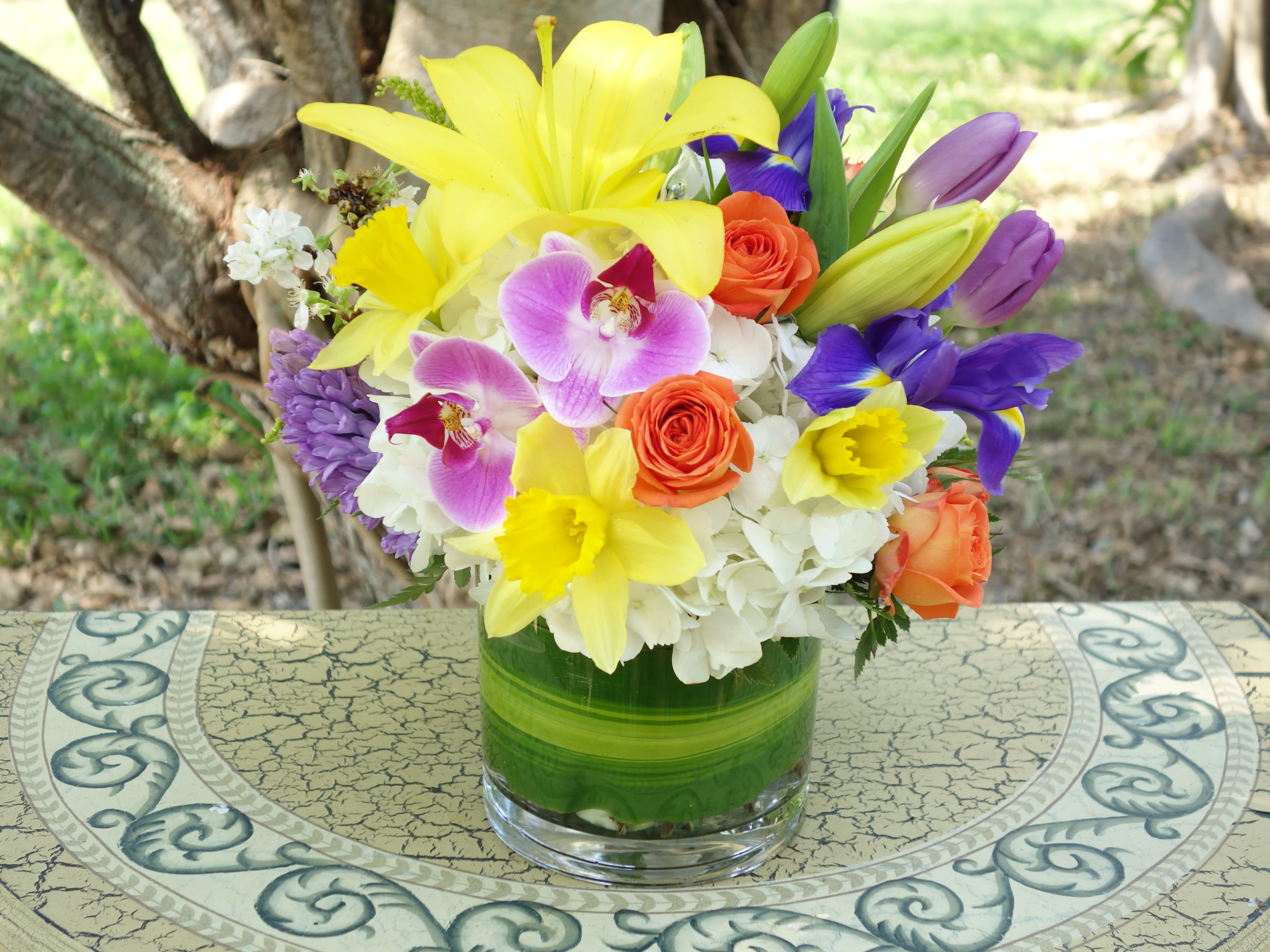 Endless Spring Bouquet - Exhibiting clean lines, gorgeous textures, and an unmatched sophistication, this fresh flower bouquet is set to send your meaningful sentiments to your special recipient. Beautiful at every turn, this flower arrangement brings together brilliant yellow Asiatic Lilies, orange spray roses, fragrant hyacinths, irises, orchids, daffodils, tulips and a blooming hydrangea with an assortment of lush greens. Presented in a superior heavy glass oval vase meant to dazzle and delight your recipient for years to come, this fresh flower bouquet will make an excellent birthday,spring, just because, or thank you gift.