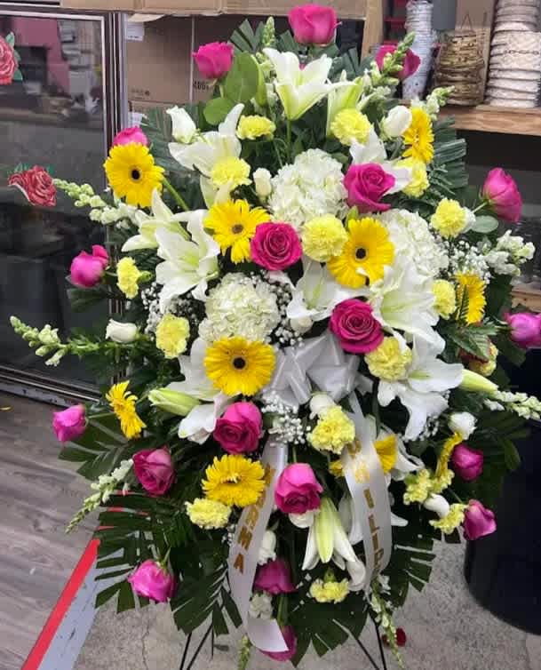 Pink &amp; yellow Sympathy Spray - Medium Sympathy spray pink, yellow, and white Includes Roses, carnations, Lilies, Hydrangeas Metal stand included*