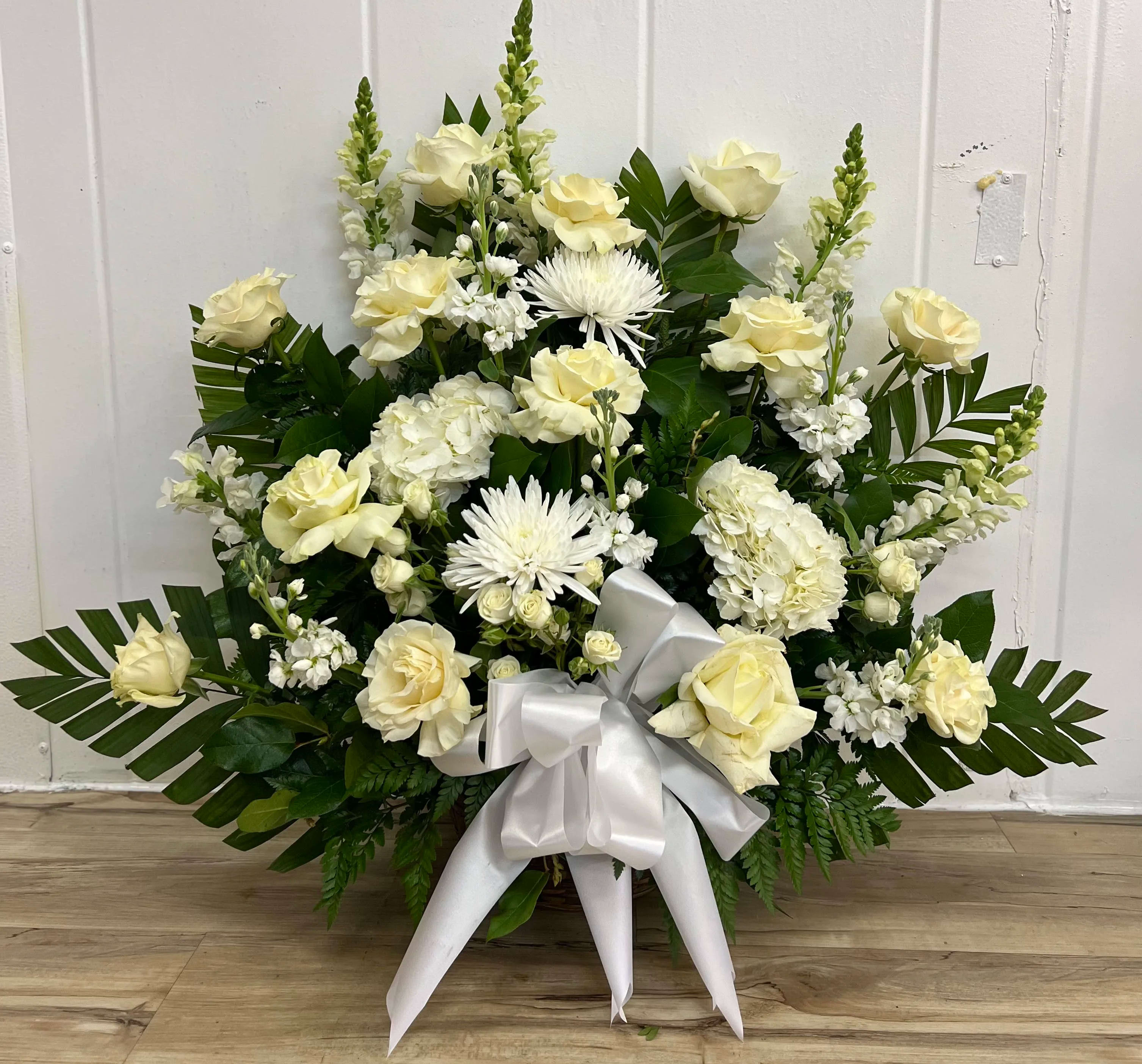White Sympathy Basket - 1 Dozen white Rose basket for sympathy Includes Roses (opened), carnations, lilies, and hydrangeas includes other filler flowers with greenery.