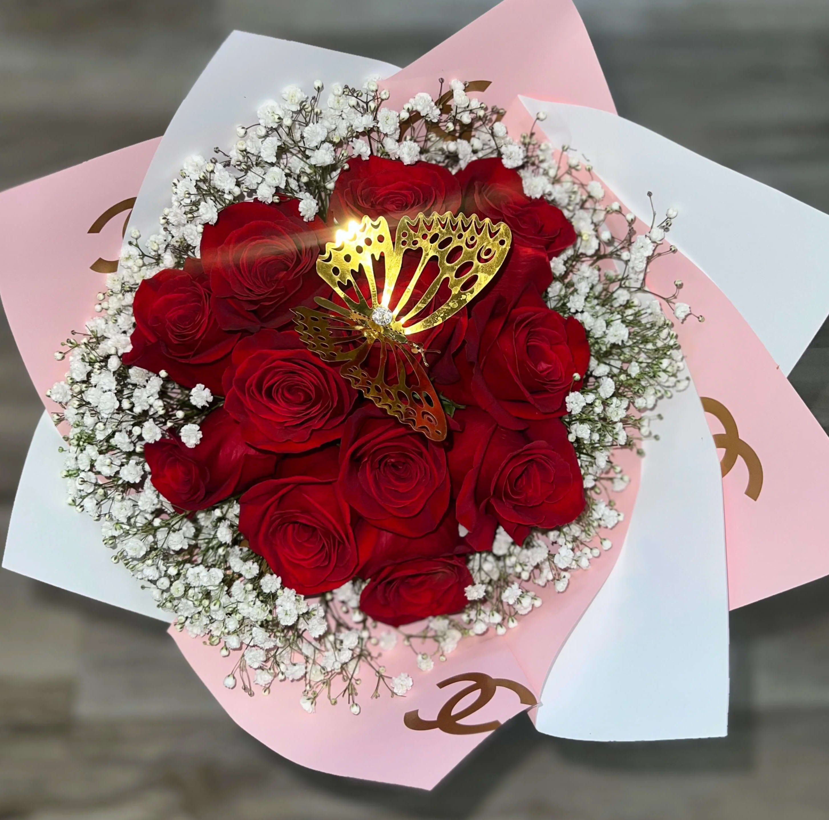 1 Dozen Roses - 1 Dozen red roses wrapped in paper with baby breath surrounding. 