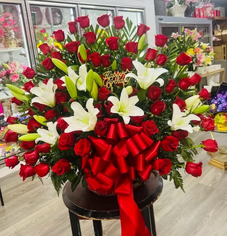 50 Red Rose Arrangement - 50 Red rose arrangement in a large basket with white lilies and large red bow. 