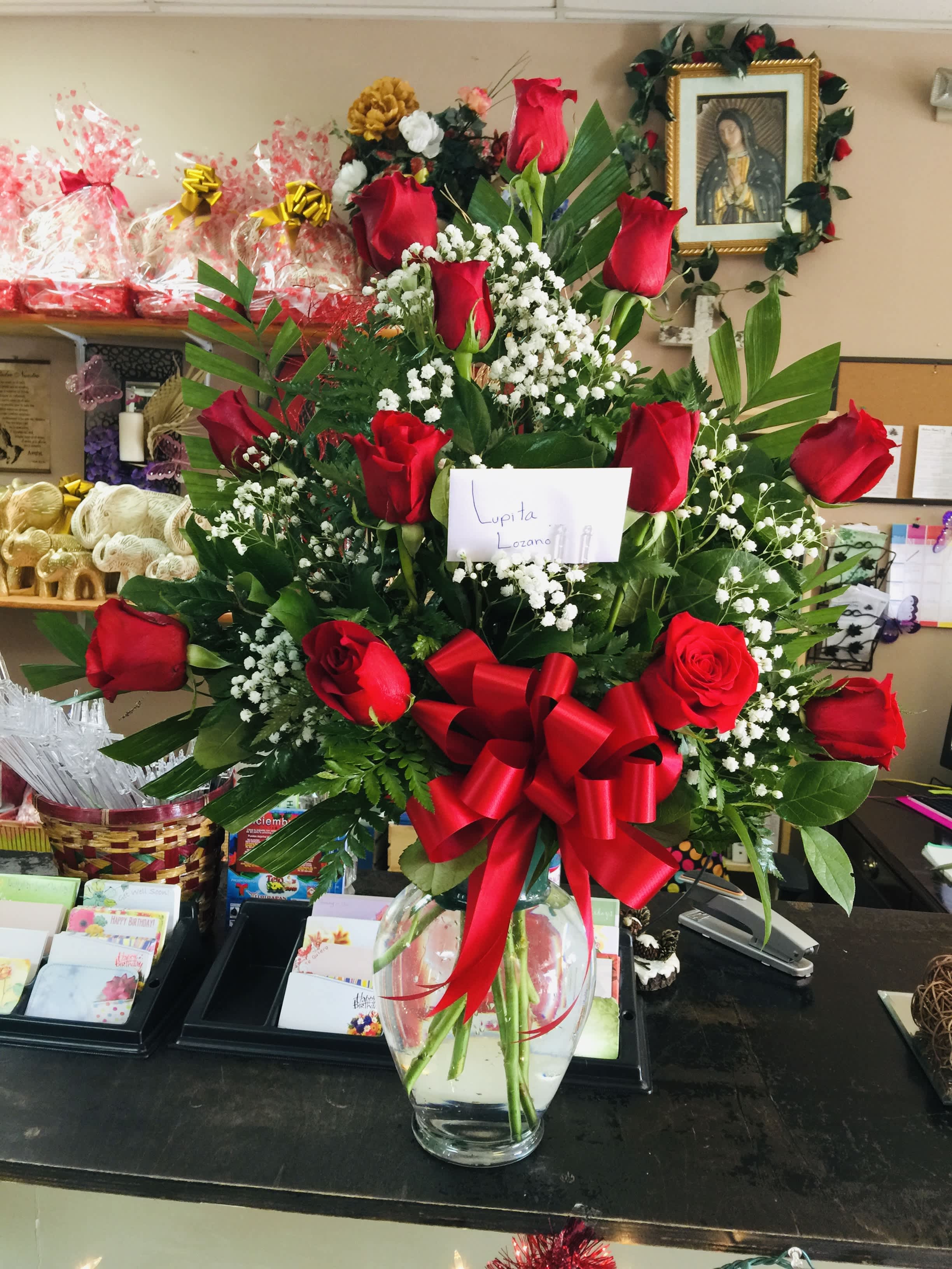 12 Rose Arrangement in glass vase - Red rose in a vase with baby breath and filler green.