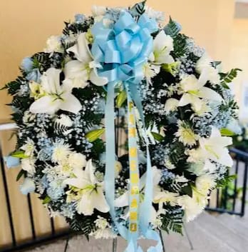 Baby blue &amp; white sympathy wreath - Medium size standing sympathy wreath  Mixture of flowers Roses, Carnations, lilies &amp; other filler flowers. Baby blue and White