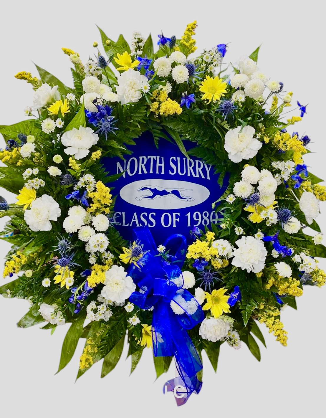 School Spirit Wreath - Send a final tribute by showing your school spirit with this wreath, this one has an authentic class shirt in the background (not provided) and done in school colors. Available in any color you choose. 