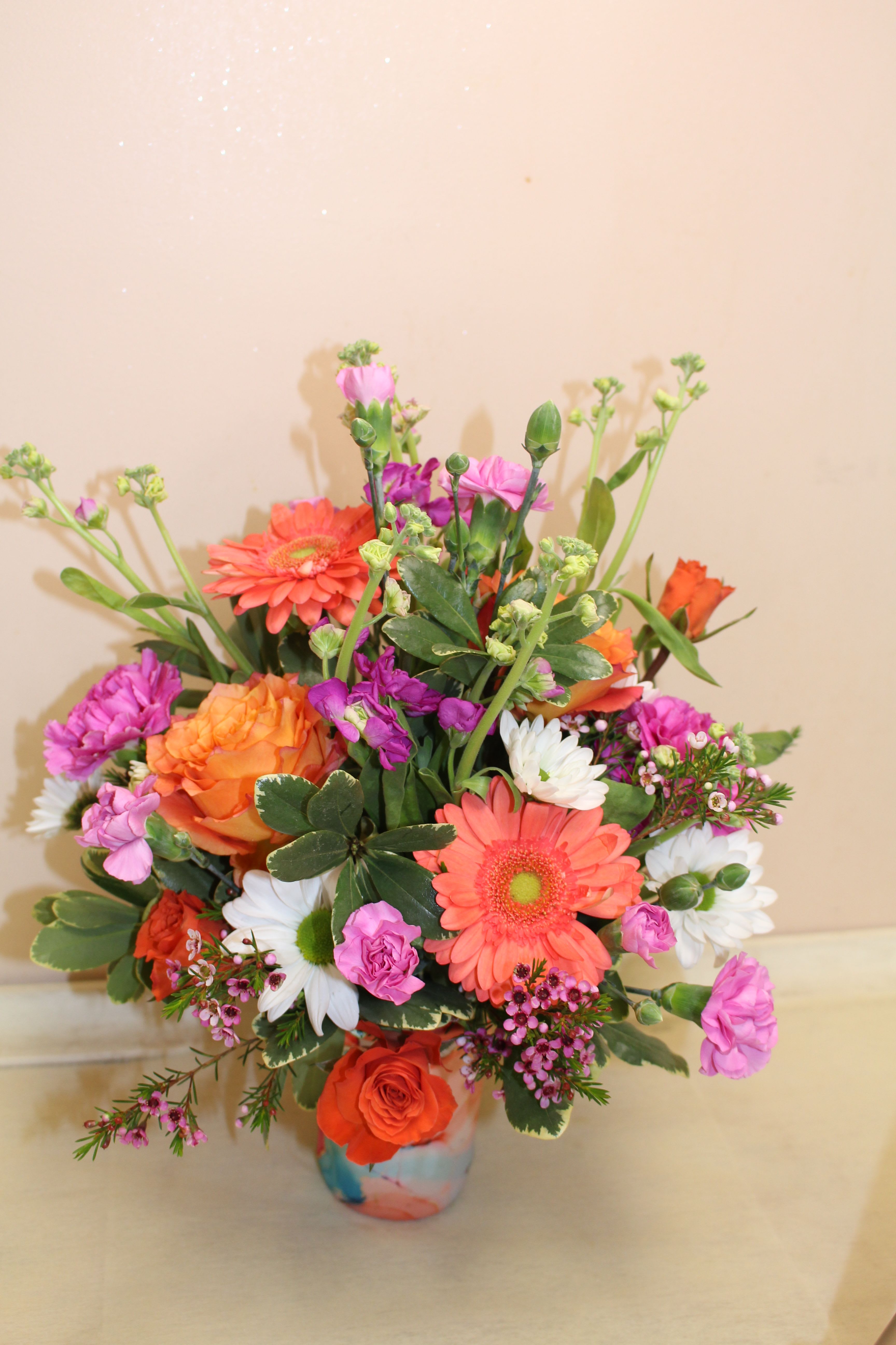 Swig Dreamsicle Iced Cup Coolie and Flowers - A flower arrangement fills a Coolie - What a great gift Cool drinks, dry hands!  Cool off with the chill swirls of dreamy pink, aqua, and orange hues laced with streams of gold.  Our insulated Coolies stop condensation and keep drinks cold for 2+ hours. Our lightweight Iced Drink Cup Coolie can be carried anywhere and stores away flat, making it a carpool to office must-have! Crafted from durable, high quality 3mm thick neoprene Keeps drinks cold 2+ hours Designed to fit medium iced cups: Dunkin® Medium, Starbucks® Venti, McCafé® large &amp; Other 22-28oz Cold beverage cups Features easy-grip hand strap Stops messy drips Keeps hands dry &amp; warm Flexible, lightweight and durable Machine washable Great on-the-go, folds flat Measures: 5&quot; H x 5&quot; W (at widest when flat) x 3.5&quot; D