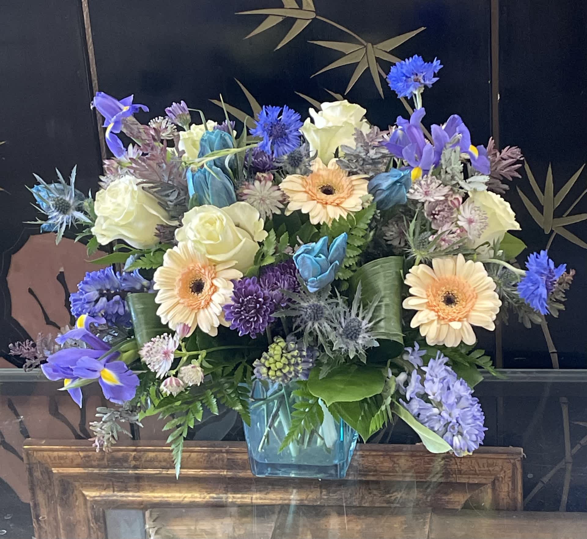 Blue's Clue Blue's Clue - Great for anyone who loves the hues of Blue! The Vibrance and contrast of blue colors in this arrangement will definitely clue your love in on your admiration for them.. for sure!