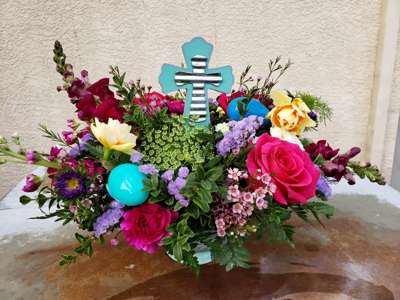 Cross my Heart Cross my Heart - This gorgeous centerpiece has an abundance of spring flowers like, snapdragon, carnations, and roses. Plus a keepsake cross to enjoy! (crosses may be similar to picture)