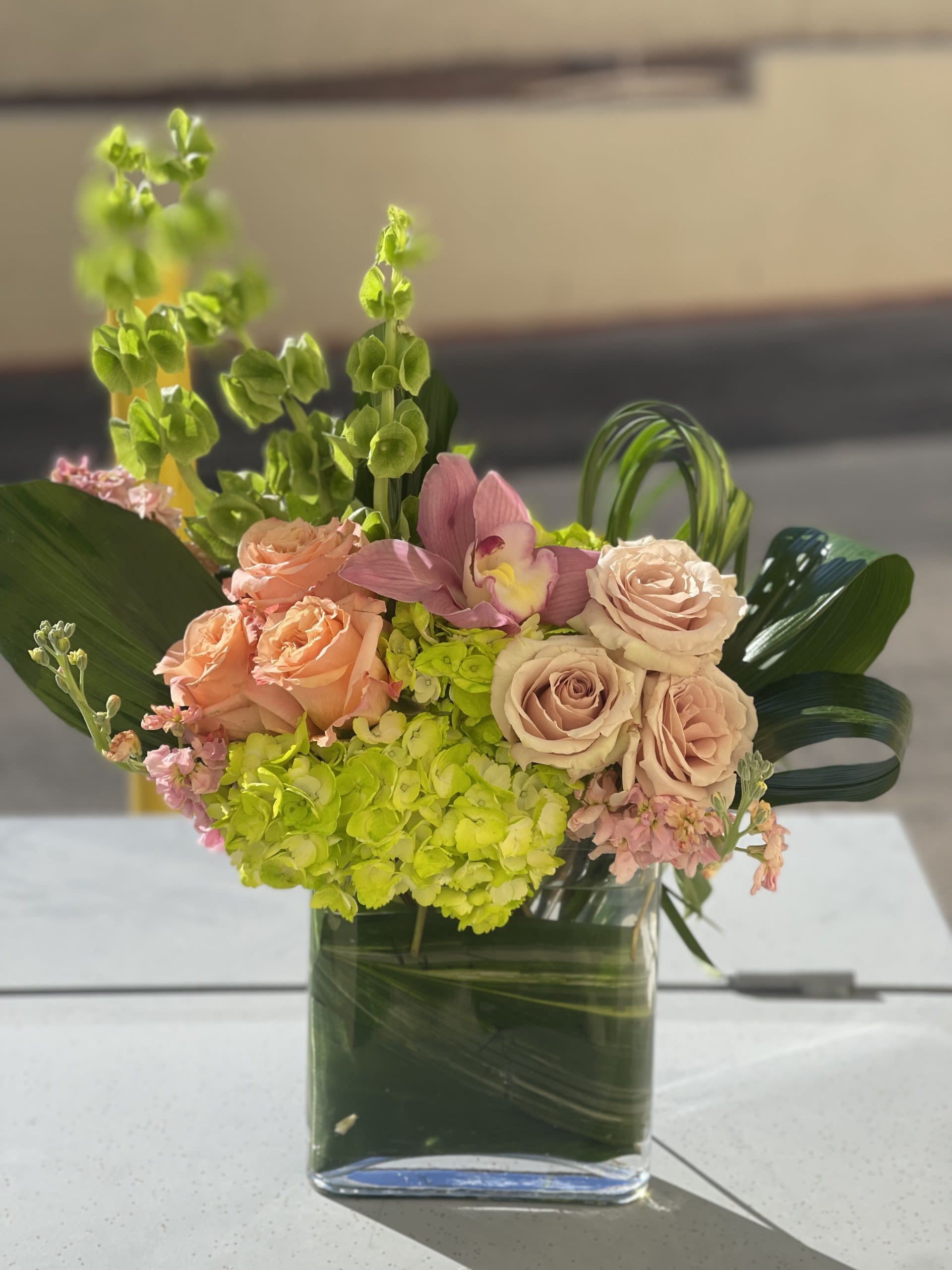 Delicate Dreams Delicate Dreams - A soft and delicate floral design of blushing pink roses and cymbidium orchid, with kisses of lime green hues.