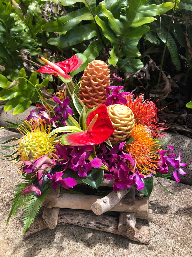 Driftwood Dreamscape (NATIONAL SHIPPING) - Our Hawaii Aloha arrangement is created with the finest tropical flowers grown on the islands , magnificent colors, fascinating textures makes these beautiful blooms breathtaking. We have designed this arrangement in a vessel that is handmade on Maui, with natural driftwood collected from the shores of the island. Send Hawaii’s Aloha today!