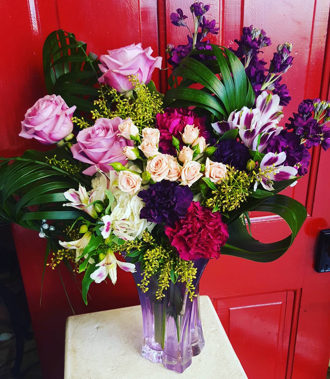 Lavender Abundance Lavender Abundance - an abundance of different florals, from roses amd hydrangea, to carnations, stock, and alstromeria. perfectly framed with braided commador leaves and gorgeous accent greens.