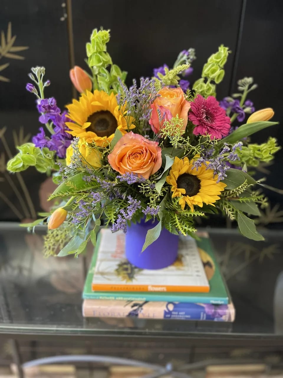 SWEET SUMMER SWEET SUMMER - A lovely collection of greenery and variety of seasonal flowers like, sunflowers, roses, gerberas, and array of airy fillers for a full, lush bouquet.
