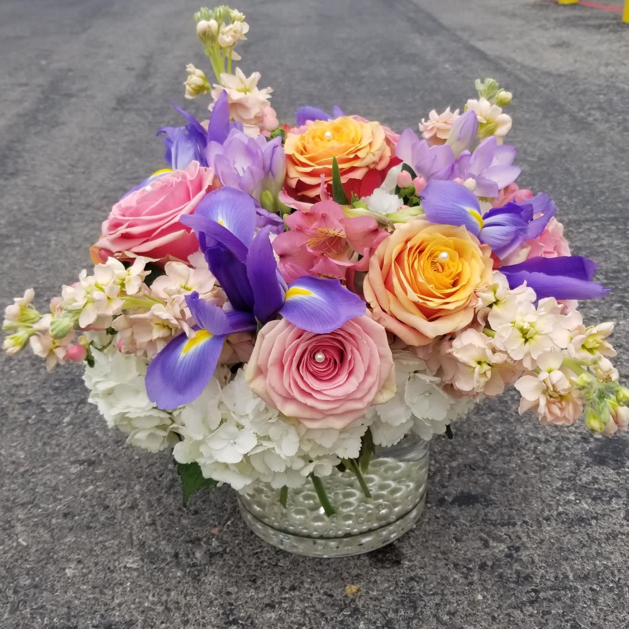 Uptown Girl Uptown Girl - Excite your uptown girl with this fabulous design filled with fluffy white hydrangea, iris, roses, and billowing stock.