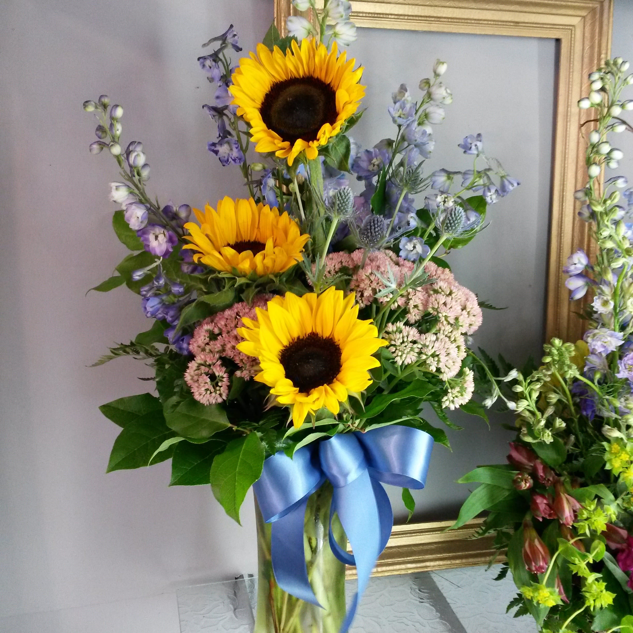 "Sunny Days " "Sunny Days " - Arrangements of sunflowers and delphinium and rice flowers