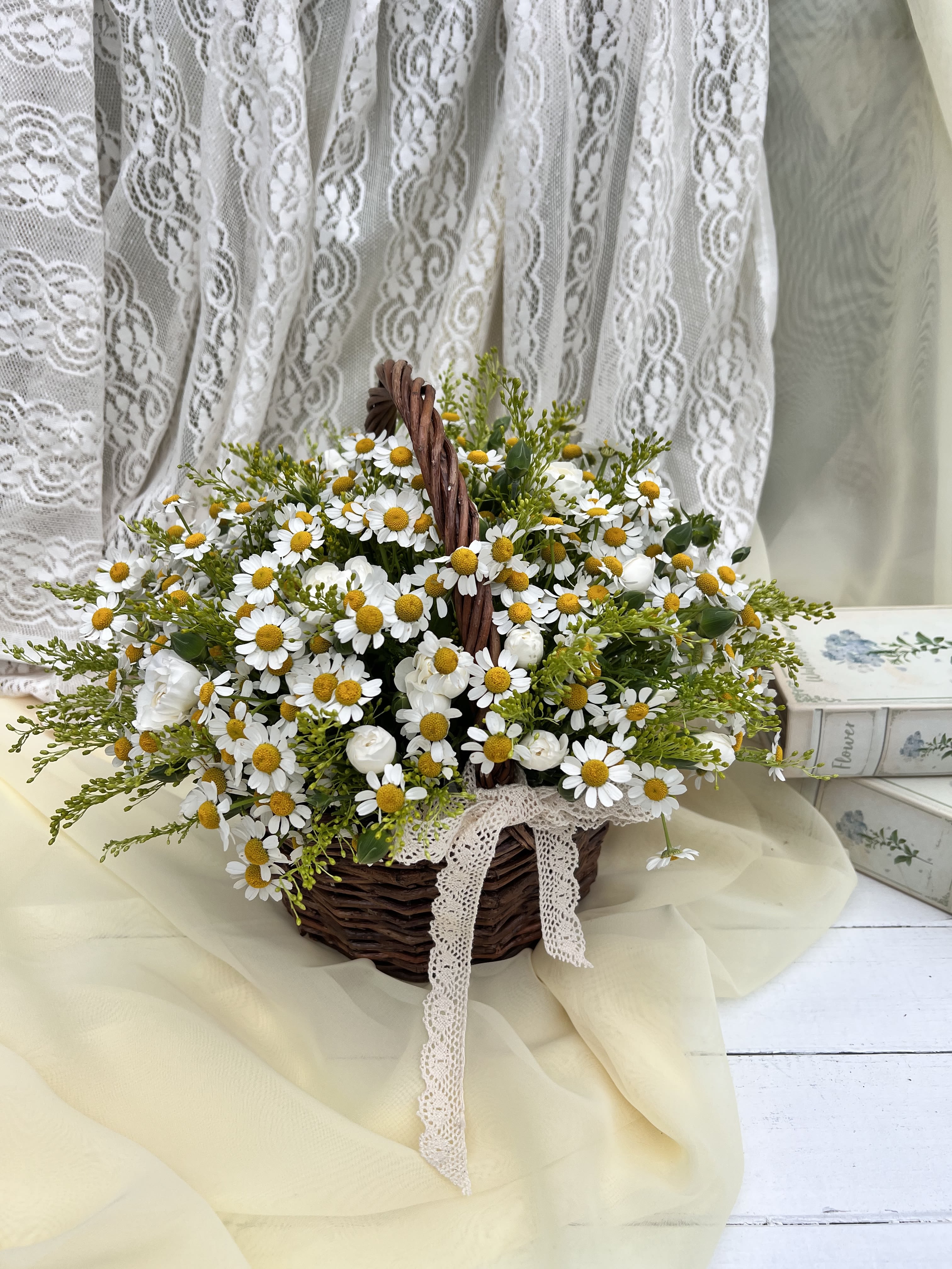 52S- Daisies Basket - This charming basket arrangement features an abundance of pure daisies, symbolizing innocence and cheerfulness. The simplicity of the white petals and sunny yellow centers creates a fresh, uplifting display, perfect for brightening any room or sending a message of joy and warmth. Ideal for casual occasions, get-well wishes, or just because! STANDARD size is shown in the picture
