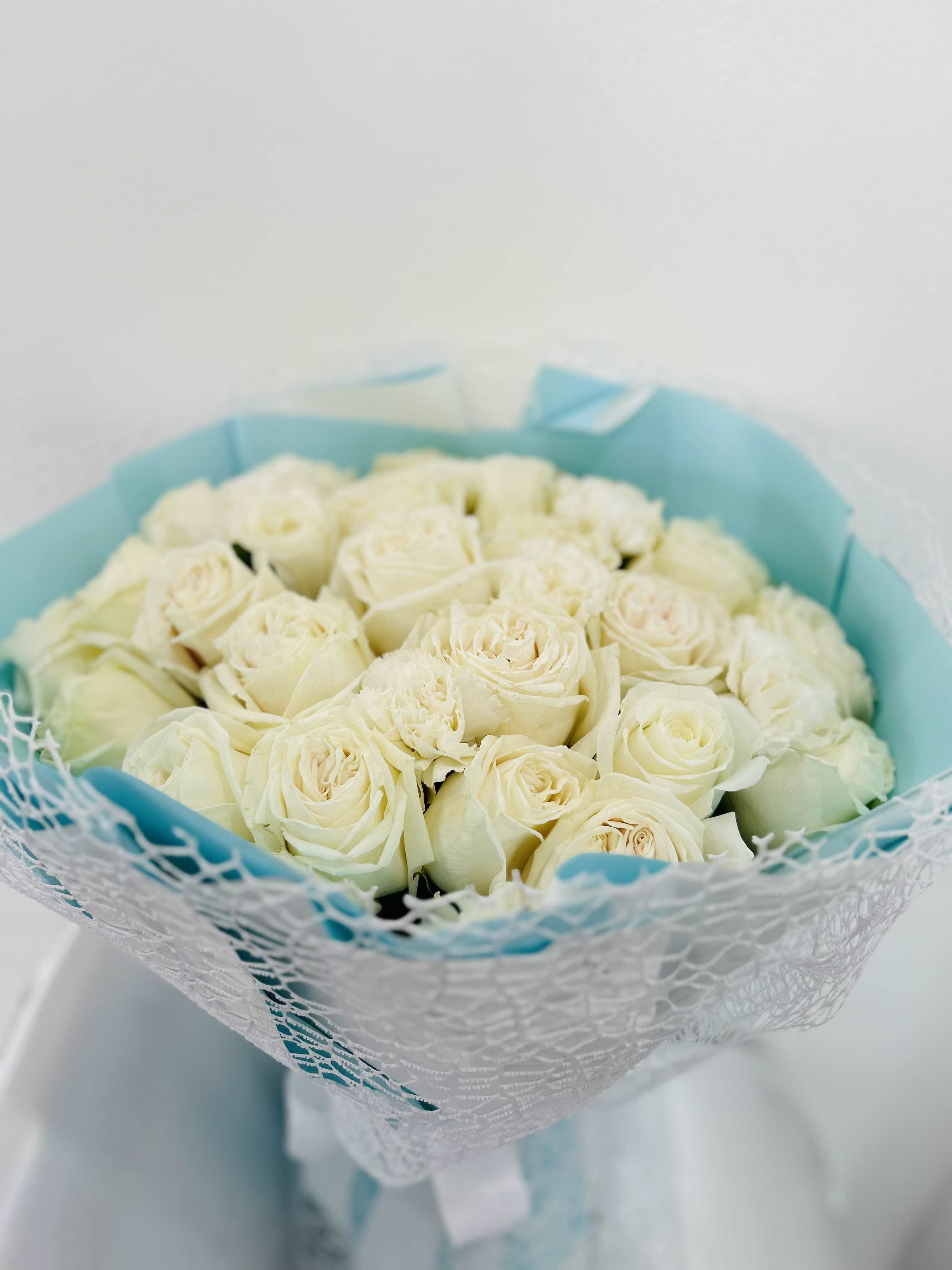 White roses with blue wrapping - White roses hand bouquet. NOTE: Any wrapping colors available.