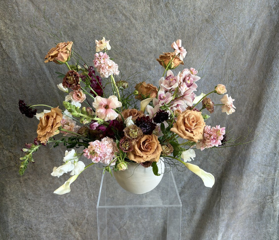 Warm Spice Warm Spice - "Warm Spice" is a rich and inviting floral arrangement that exudes comfort, warmth, and a touch of exotic allure. With a harmonious blend of deep, earthy tones and soft, spicy hues, this arrangement evokes the cozy, intimate feeling of a fall evening or a cherished gathering. The warm colors create a sense of depth and richness, while subtle textures add layers of intrigue. Perfect for creating a welcoming atmosphere, "Warm Spice" brings an element of bold elegance to any occasion, making it ideal for seasonal events, cozy celebrations, or simply adding a touch of warmth to your space.