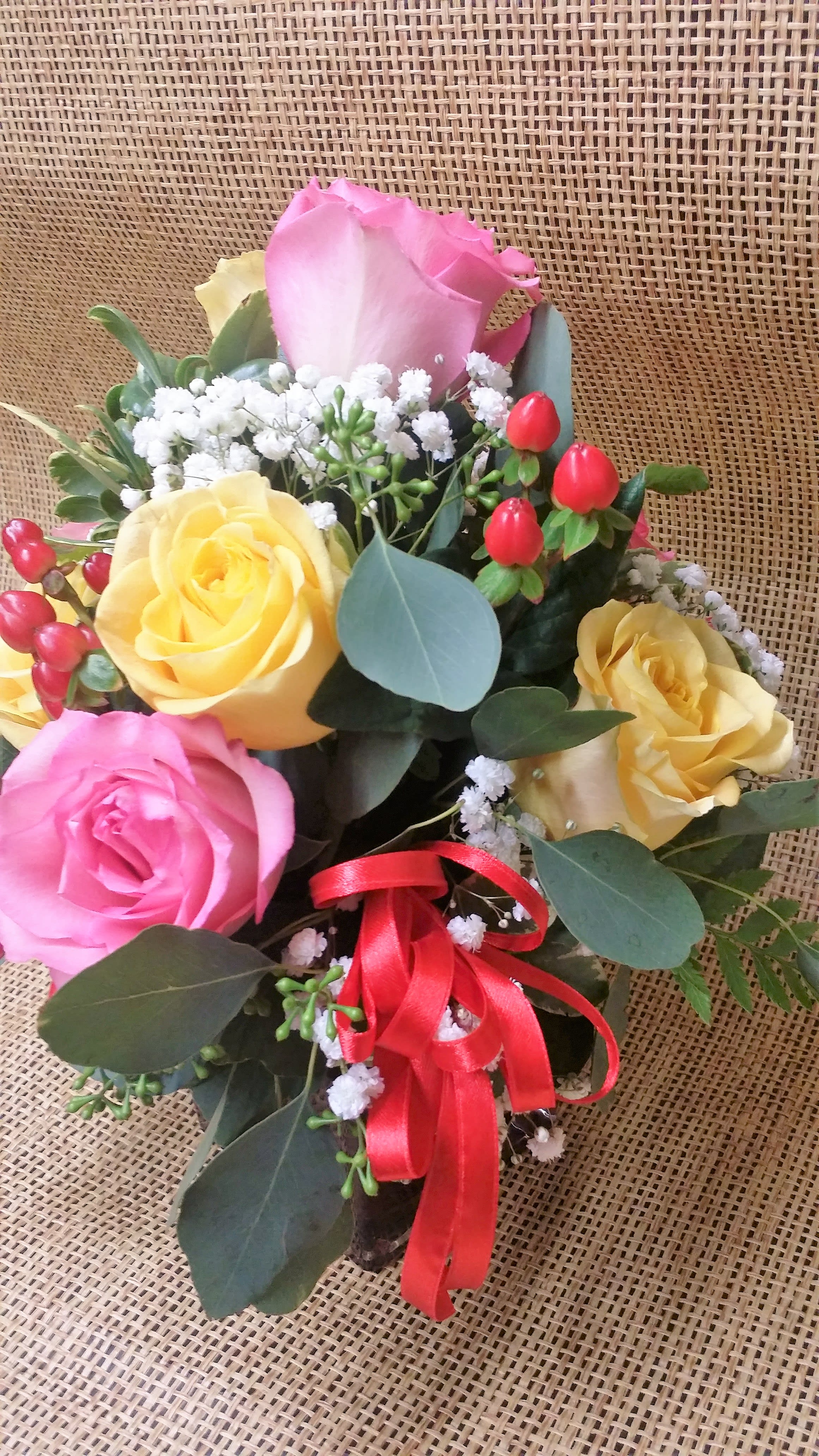 Berry Beauty - Lush mixed roses, white baby's breath and red hypericum berry sprigs in a cube vase will add a bright spot to anyone's day.