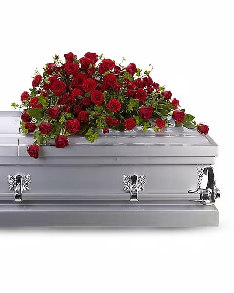 Red Rose Reverence Casket Spray Red Rose Reverence Casket Spray - Red roses tell a story of love, beauty, and strength. This all-red spray graces the casket with accents of trailing ivy. A lush arrangement of deep red roses and carnations, accented with gorgeous green ivy.