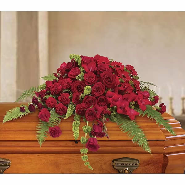 Red Rose Sanctuary Casket Spray Red Rose Sanctuary Casket Spray - A gorgeous mix of dazzling red flowers will make a grand, yet graceful impression. Beautiful red roses, spray roses, gerberas, gladioli and carnations along with vibrant green bells of Ireland create a sincere tribute.