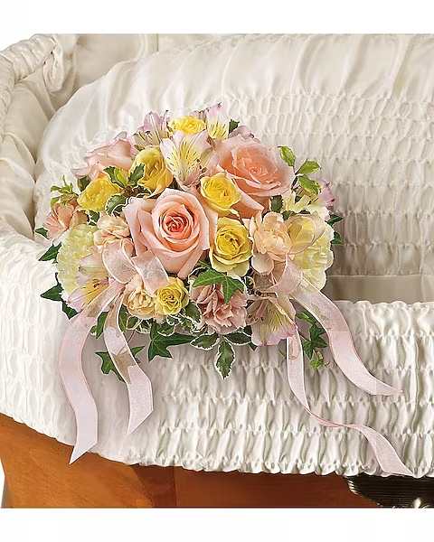 With Affection Nosegay Casket With Affection Nosegay Casket - Pay tribute to a truly special soul with this delicate arrangement of soft peach roses and yellow spray roses. Accented with ribbons and fresh green pitta negra, it's an affectionate touch. Gorgeous peach roses are arranged with light yellow spray roses, pink alstroemeria, light yellow carnations, miniature peach carnations, pitta negra and variegated ivy.