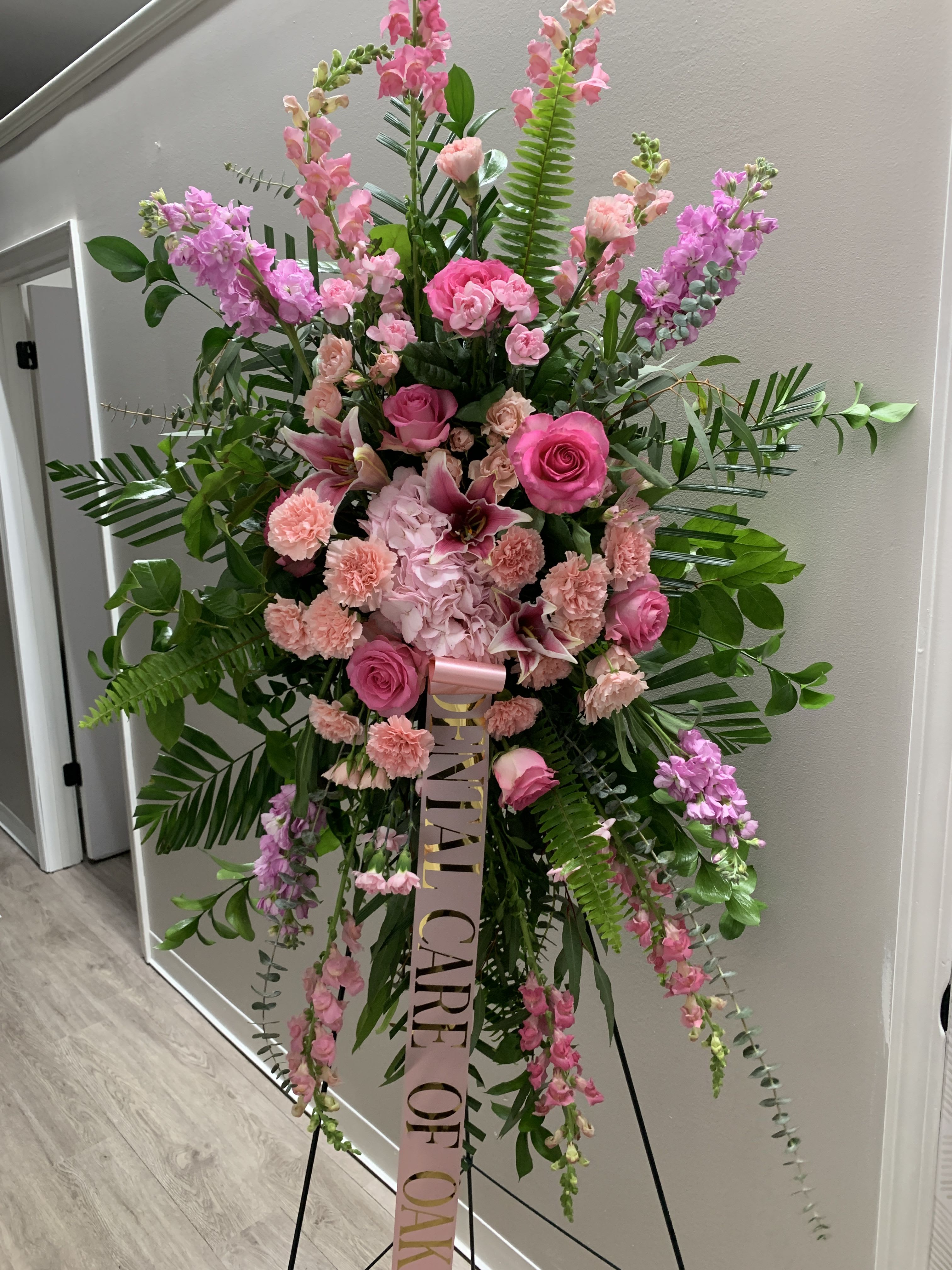 Pink Lily Spray - Pink lilies, carnations and roses on a variety landscape of greens. 