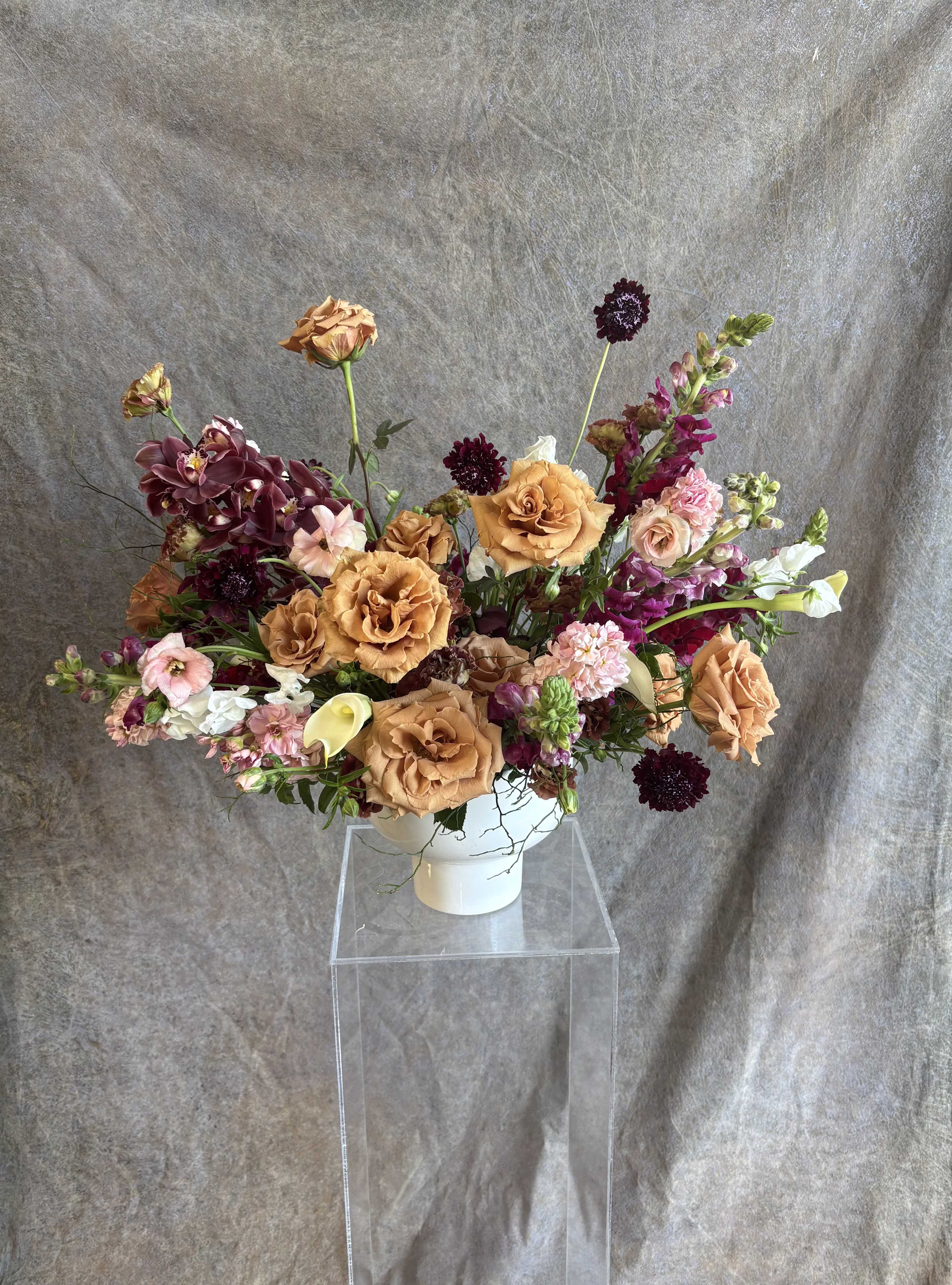 Unapologetically Moody  - &quot;Unapologetically Moody&quot; is a bold, sultry floral arrangement that leans into depth, drama, and allure without holding back. With rich tones, unexpected textures, and a striking silhouette, this design commands attention and tells a story of elegance with an edge. It’s the perfect statement piece for those who crave sophistication with soul—a celebration of shadows, contrast, and confidence. Unapologetically Moody isn’t just an arrangement—it’s a vibe all its own.