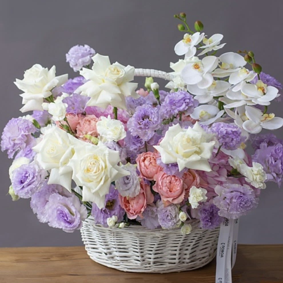 Pastel Flowers Basket - Discover the perfect blend of elegance and beauty with our luxury white and pastel flower basket. Featuring premium white roses, delicate orchids, and soft lavender blooms, this arrangement exudes sophistication and charm. Perfect for weddings, anniversaries, or as a heartfelt gift for Mother’s Day or birthdays.  Carefully arranged in a stunning white wicker basket, this floral masterpiece is ideal for decorating home interiors, hotels, or event spaces. Each bouquet is crafted with the utmost care, ensuring freshness and quality for every customer. Our Los Angeles-based floral studio offers high-quality floral arrangements with delivery options to your doorstep. Whether you're celebrating a milestone or looking to elevate your home decor, this arrangement is the perfect statement of elegance.