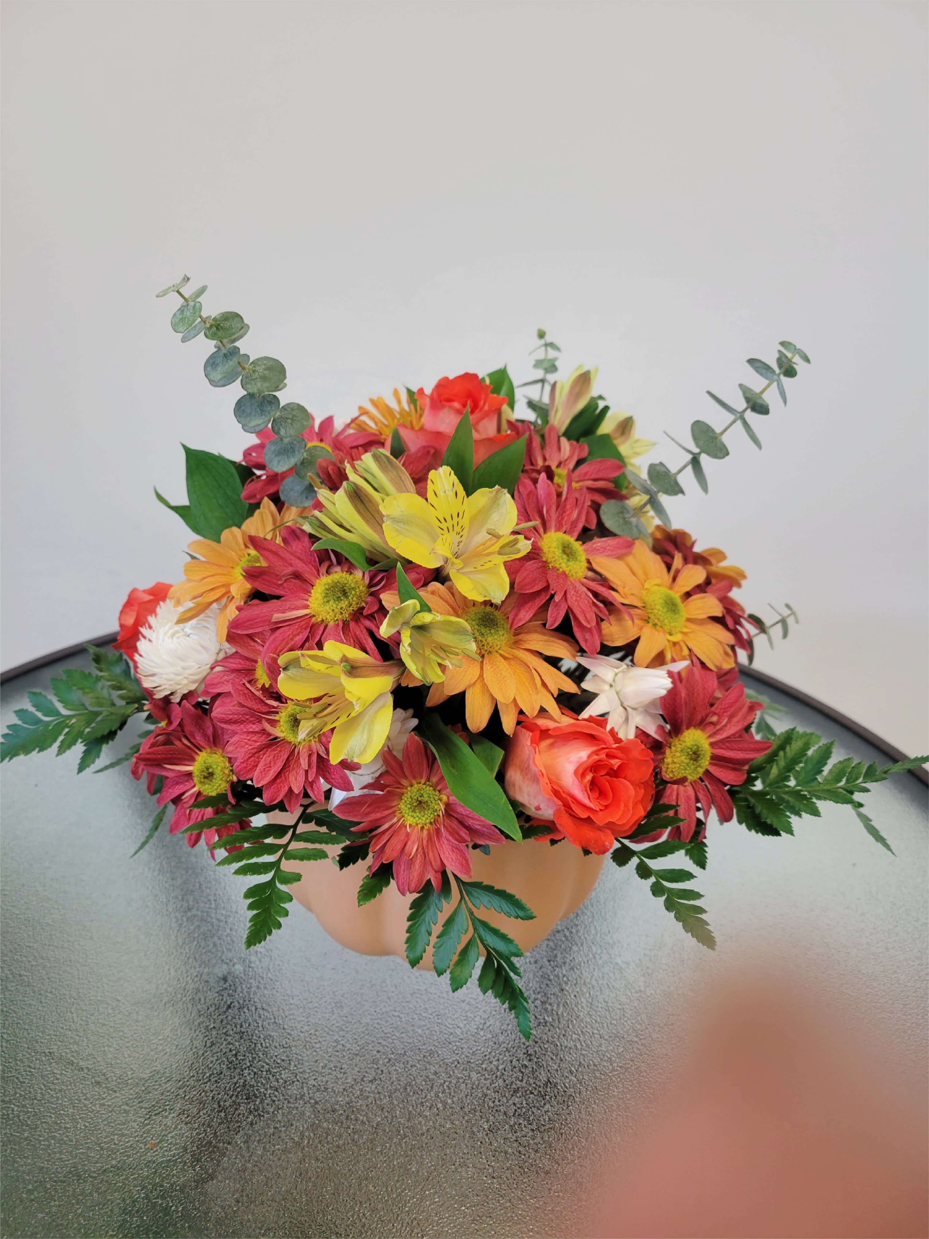 Autumn Pumpkin - Beautiful arrangement on a pumpkin base with cushion pompon, daisy pompon, roses and eucalyptus   Flowers and similar colors